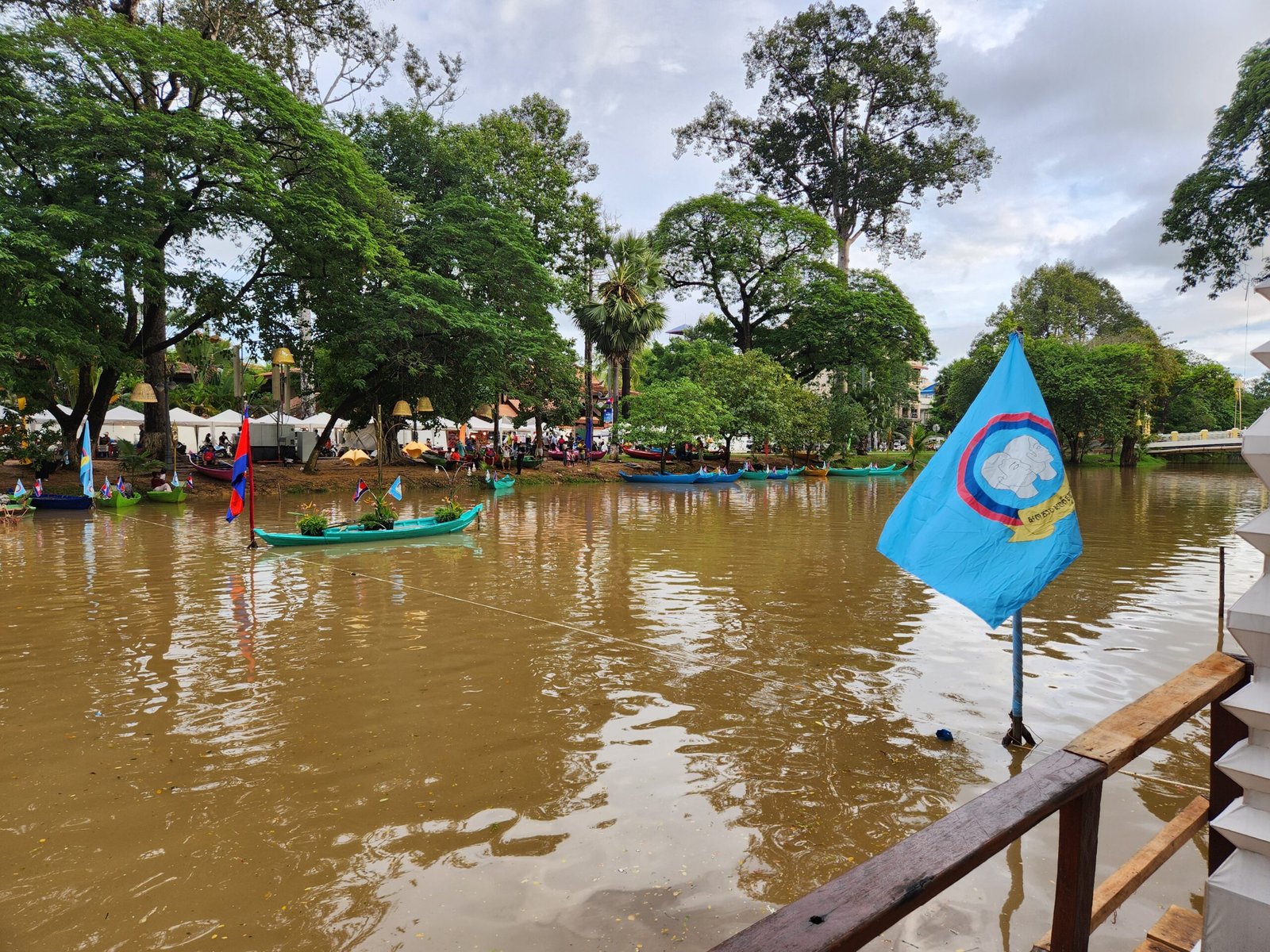The Siem Reap provincial flag waves over the festival river scene