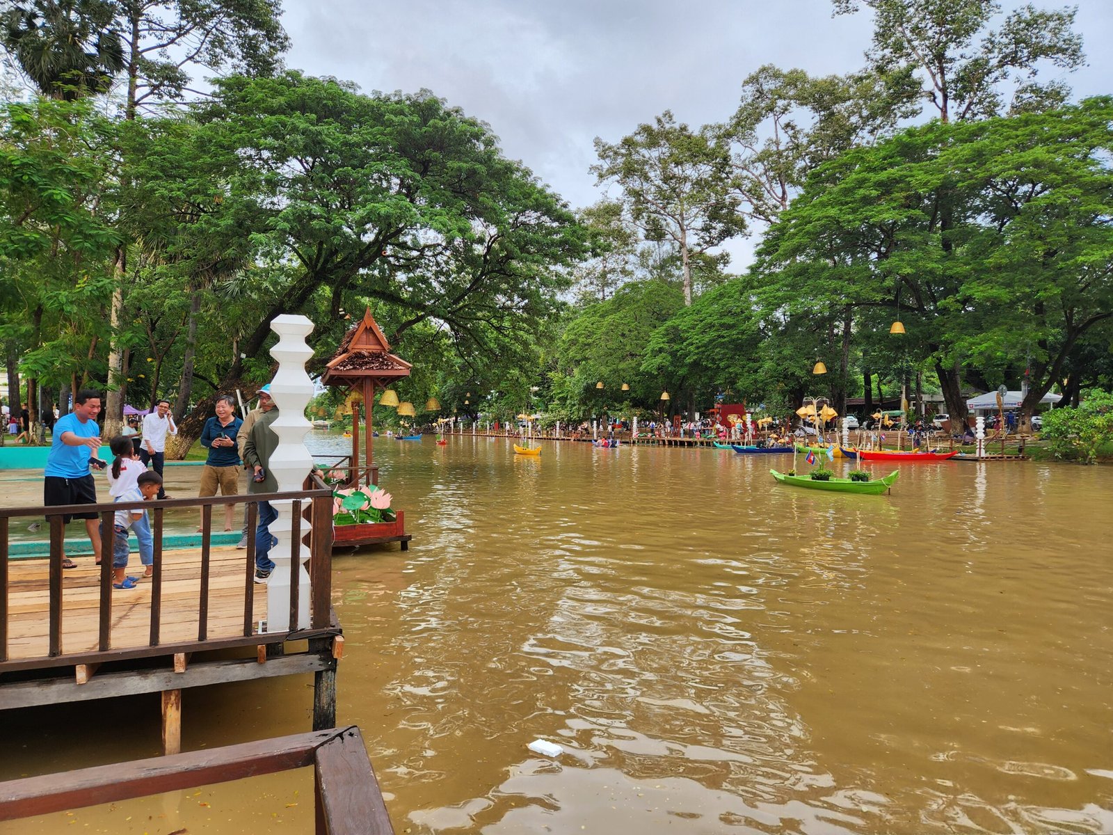 Lotus decorations and Khmer lanterns along the wooden pier