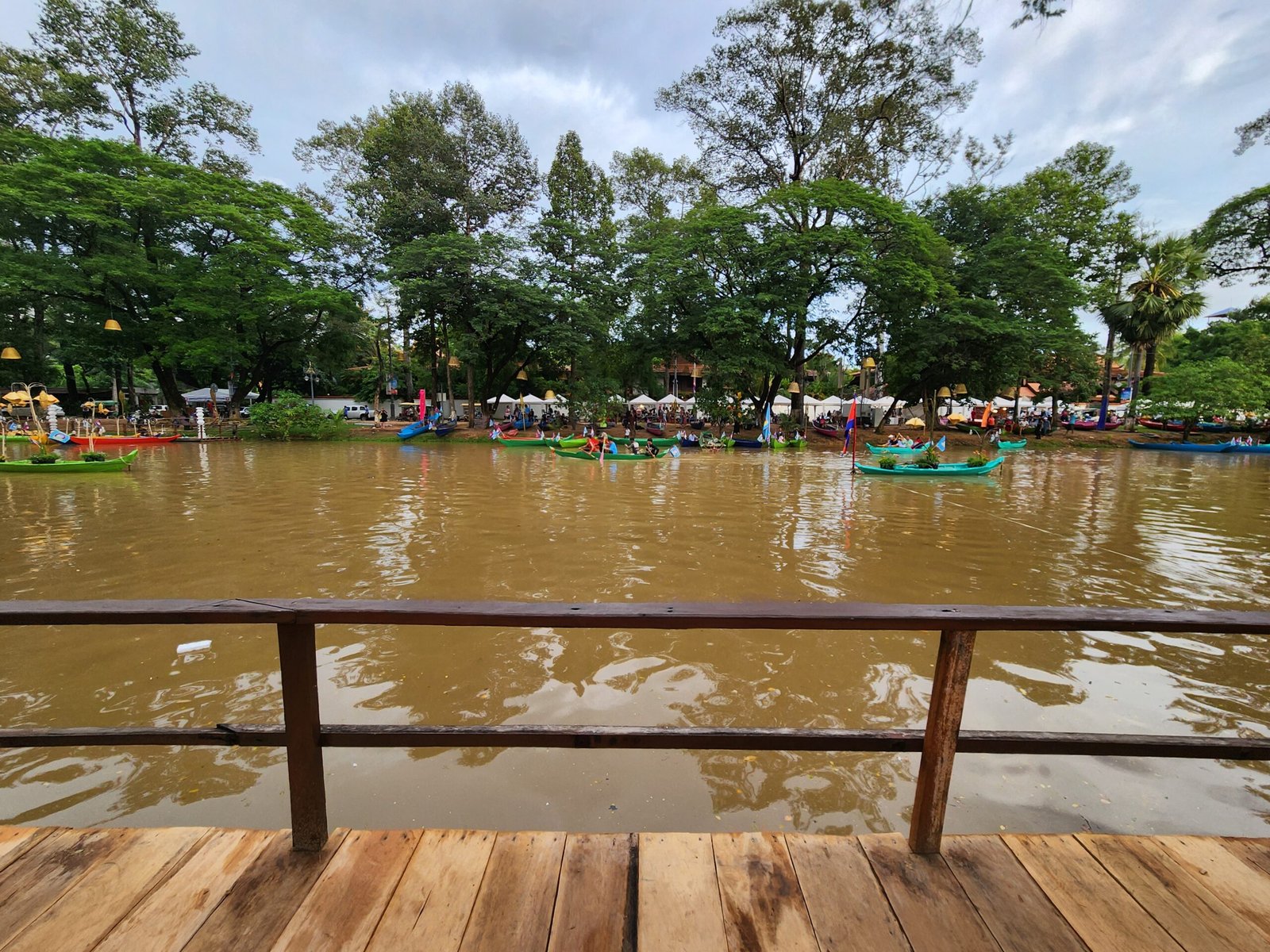 Wooden railing view of boats scattered across the water