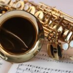 A saxophone resting on sheet music, representing the live jazz night at Lost City Pizza Society in Siem Reap