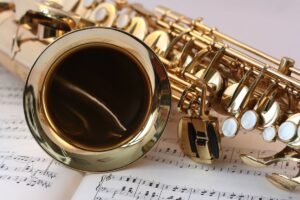 A saxophone resting on sheet music, representing the live jazz night at Lost City Pizza Society in Siem Reap